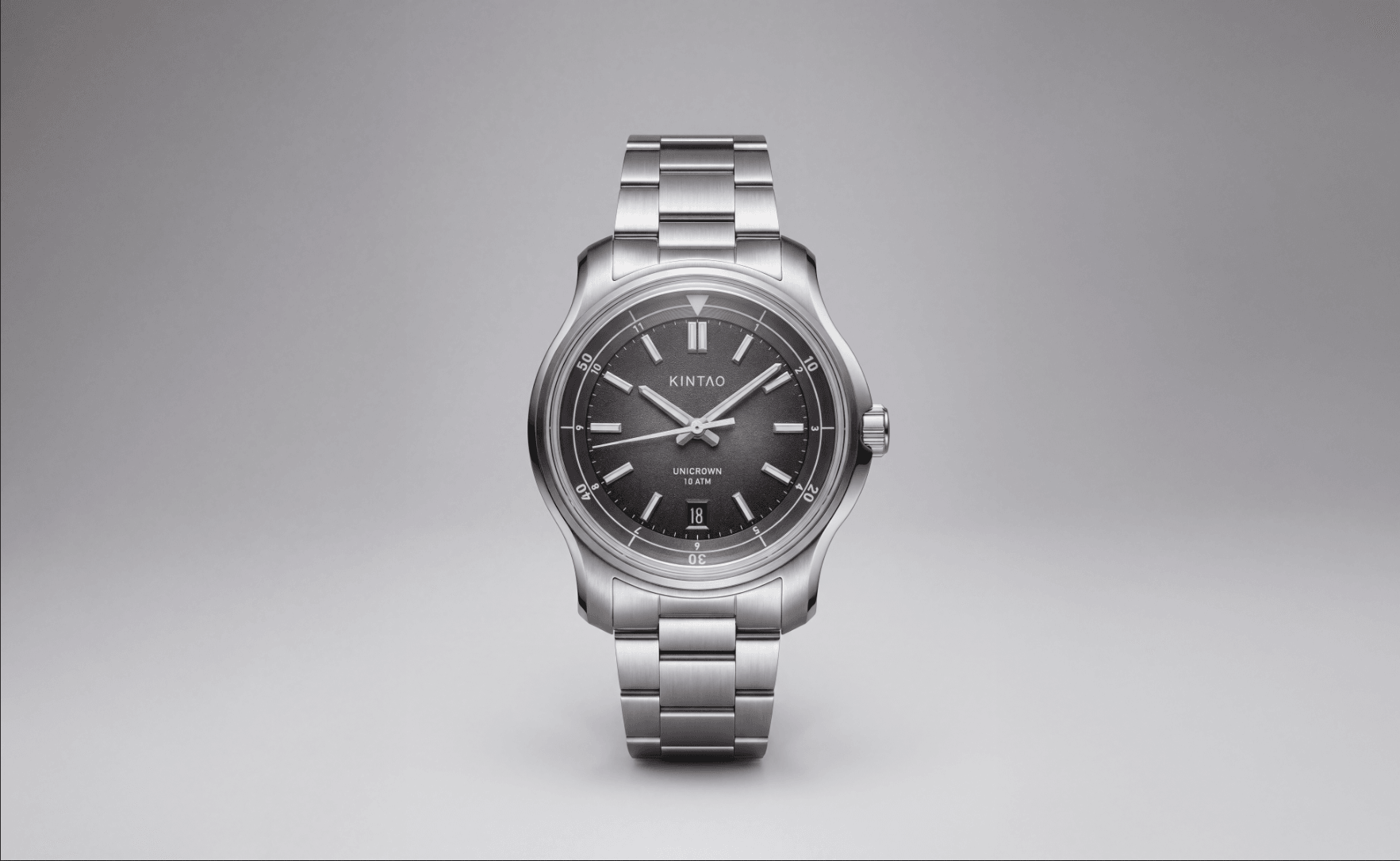 Charcoal UC1 Recurve with date on its steel bracelet, viewed from the front against a soft grey background